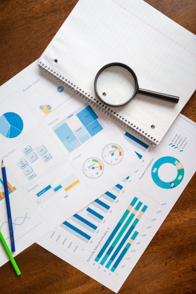magnifying-glass-on-white-paper-7948058 A set of financial charts and graphs with a magnifying glass, perfect for business reports.