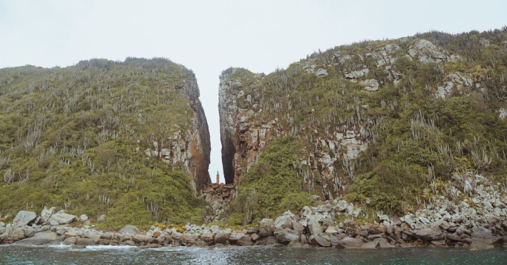 Panoramic view of a natural rock formation by the ocean, perfect for nature enthusiasts.
